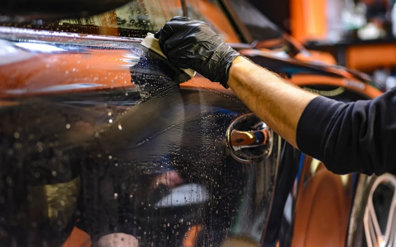 A detailer polishing a car